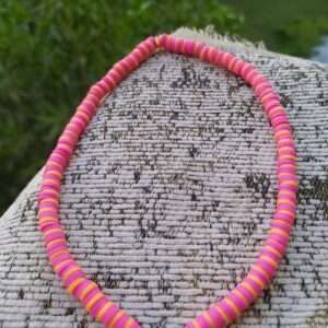 A Pink And Orange Necklace With An Eye