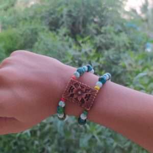 A Two Layer Bracelet With A Brown Flower