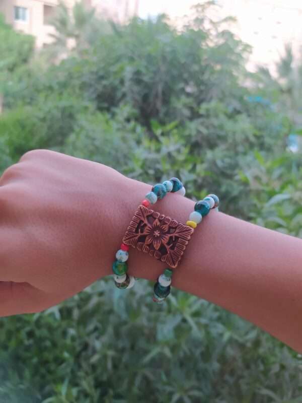 A Two Layer Bracelet With A Brown Flower